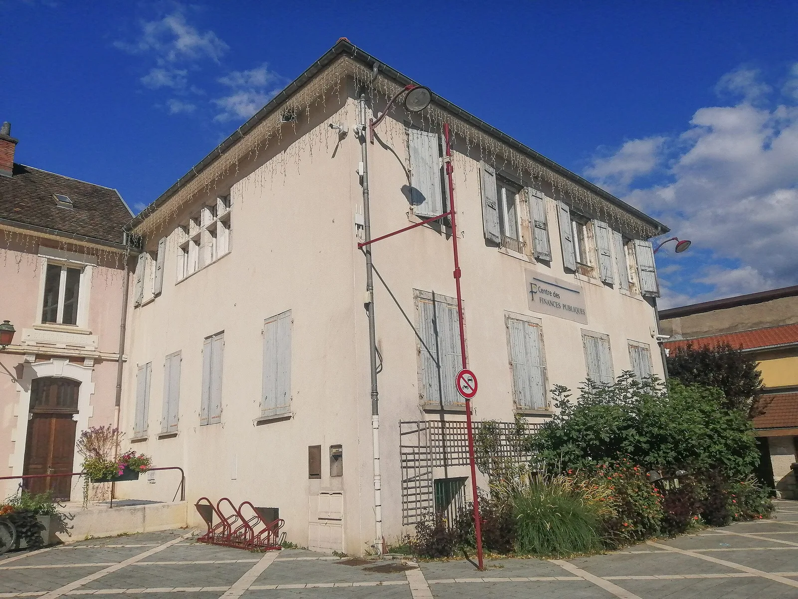 Façade d'un ancien bâtiment aux volets bleus abritant le centre des finances publiques de Vif, dans l'Isère
